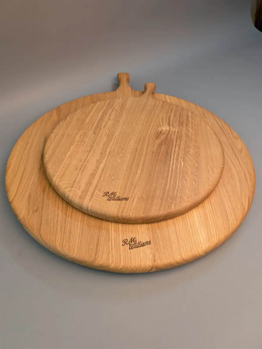 Two extra-large round wooden serving boards with handles (50cm and 70cm diameter), featuring R.M. Williams laser engraving.
