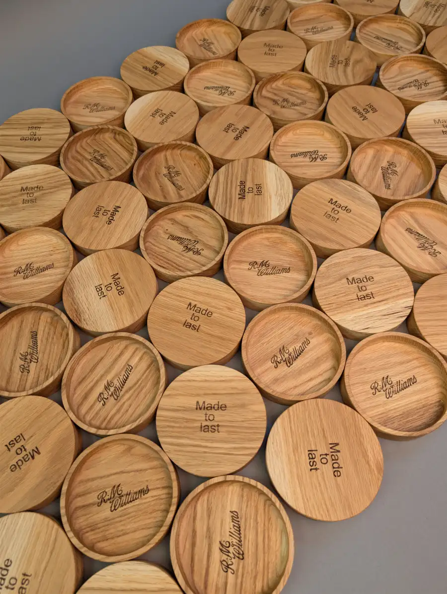 Personalised laser-engraved wooden coasters with custom R.M. Williams logos and 'Made to last' text, crafted in Edinburgh.